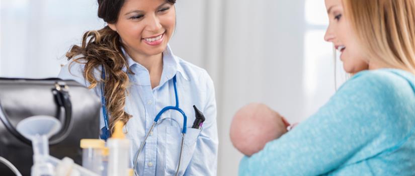 Doctor in an appointment with mother and infant going over breastfeeding supplies
