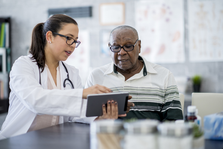 Doctor showing patient results Doctor showing patient results